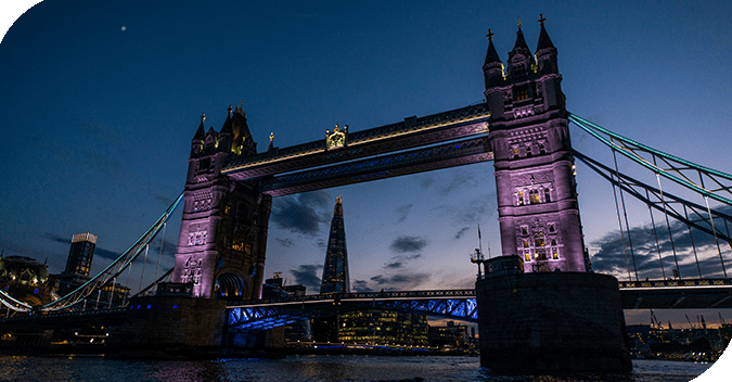 Guests enjoying a sunset yacht cruise past Tower Bridge