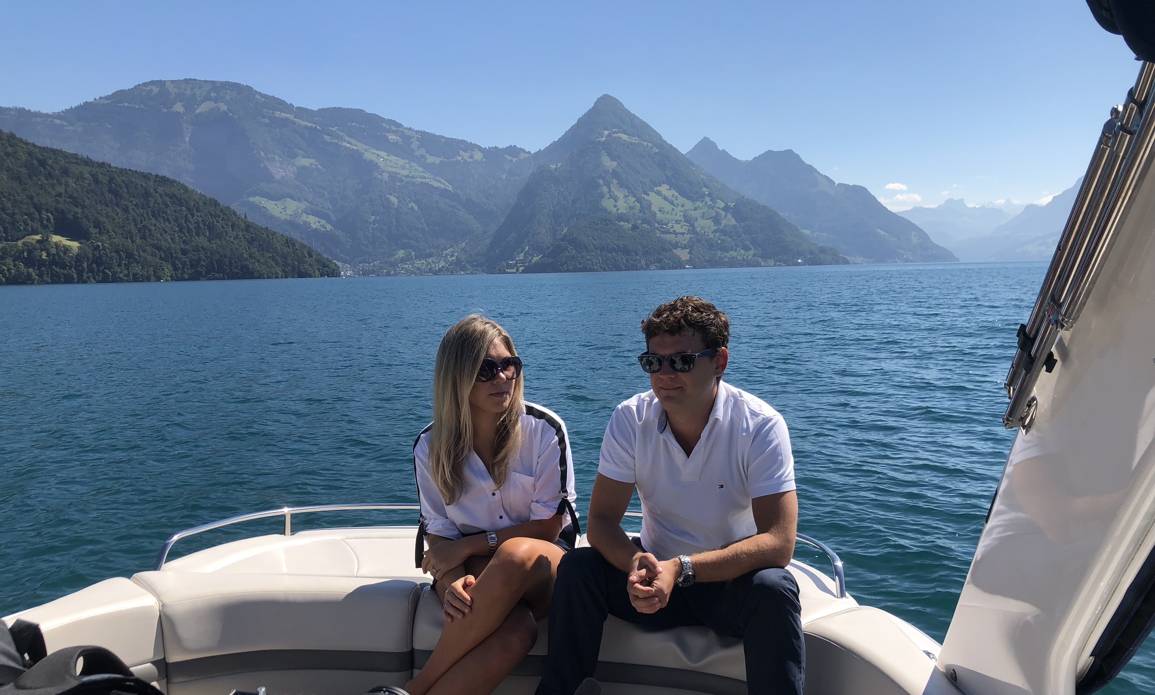 Private Yacht Charter Lake Lucerne with guests on deck - Swiss mountains in the background