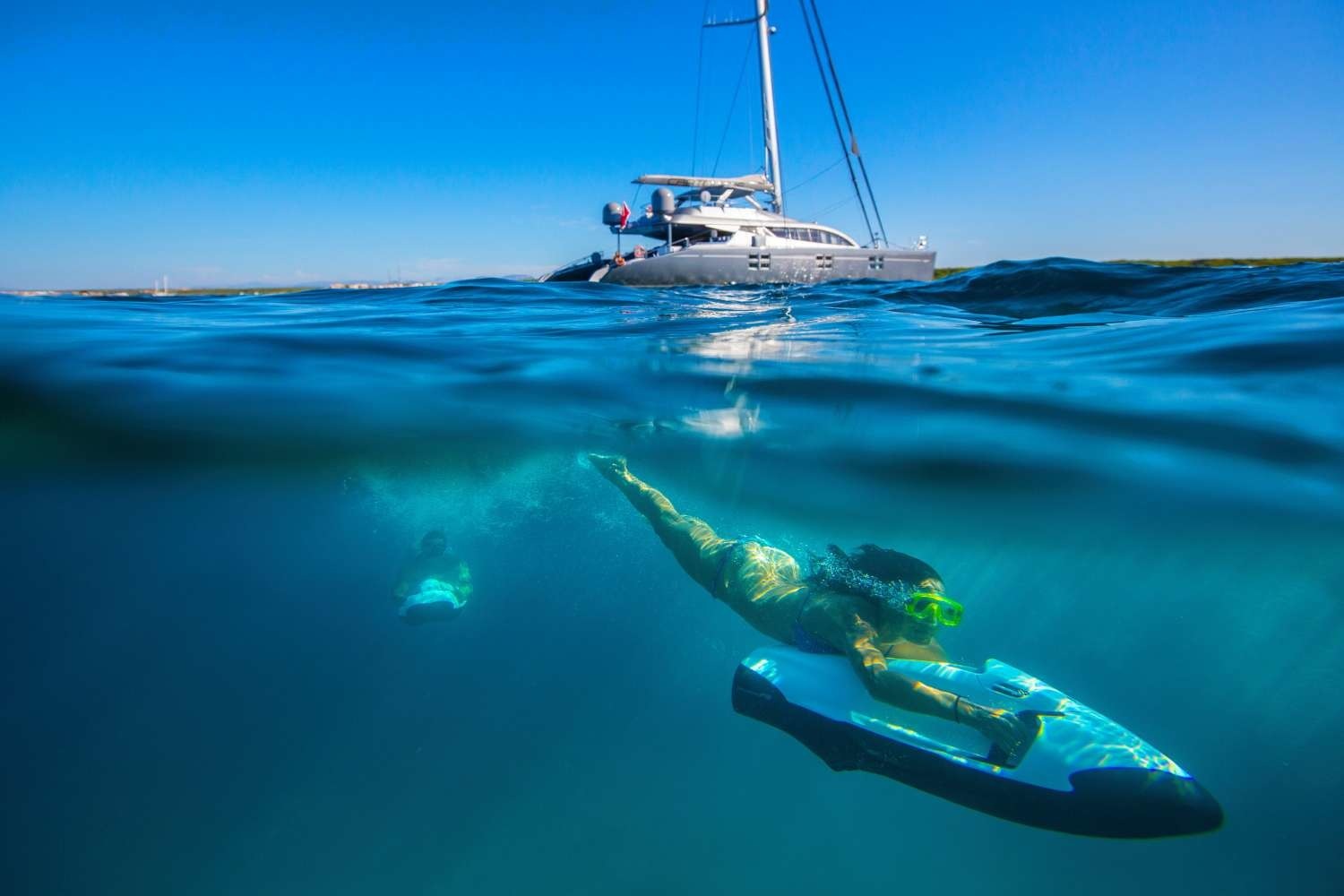 woman and man snorkeling underwater with seabob water sleds in the Maldives